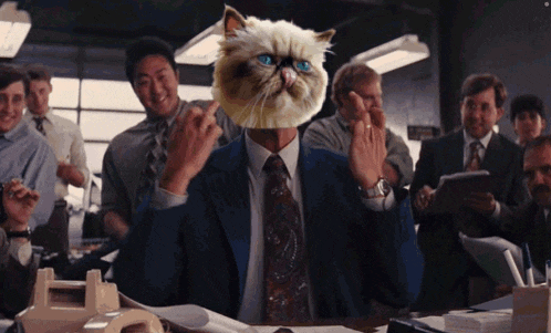 a man in a suit and tie has a cat head on his head