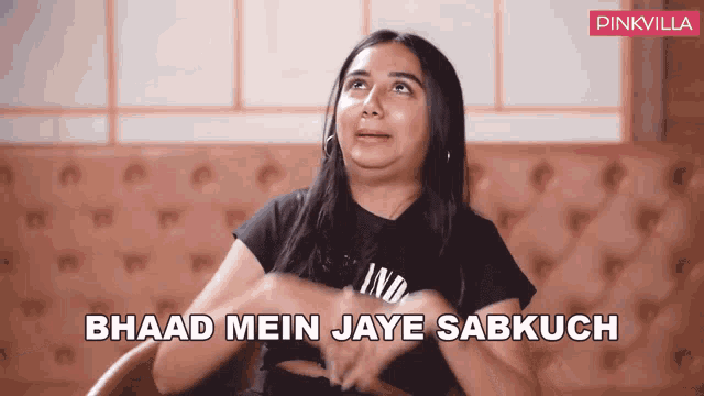 a woman sitting in a chair with the words " bhaad mein jaye sabkuch " written on the bottom