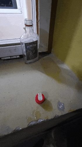 a bottle of cepkelie sits on a concrete floor