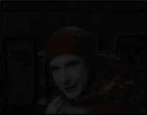 a woman wearing a scarf and a red hat smiles