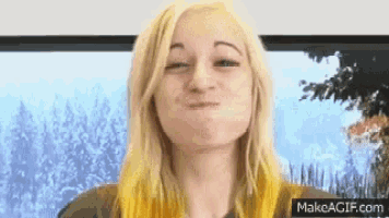 a woman with blonde hair is making a face with her mouth open .