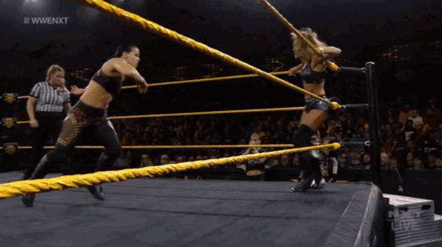 two women are wrestling in a ring with the words nxt live on the bottom of the screen