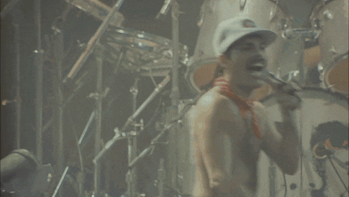 a man in white shorts is dancing in front of a crowd of people