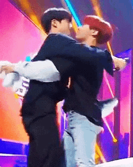 a man is carrying another man in his arms on a stage ..