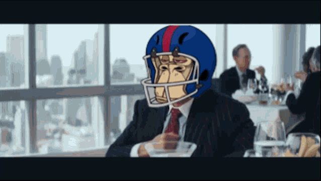 a man wearing a football helmet is sitting at a table