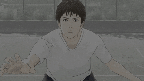 a man in a white t-shirt is reaching out his hand