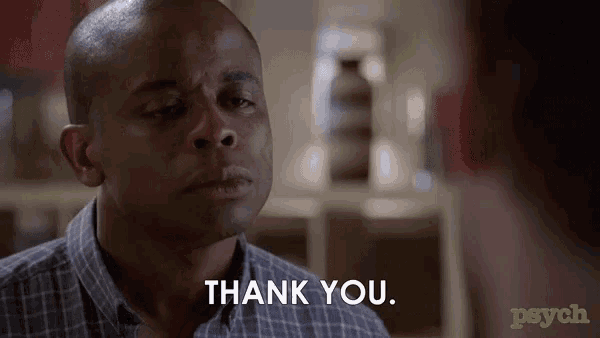 a man in a plaid shirt says thank you to another man
