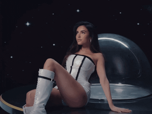 a woman in a white corset and white boots looks up