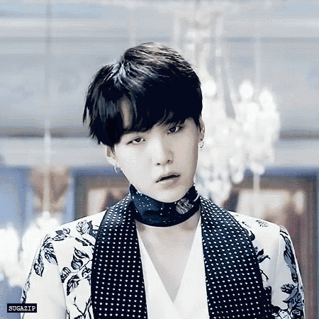 a close up of a person wearing a choker and a floral jacket .