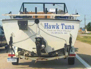 a boat that says hawk tuna on the side of it