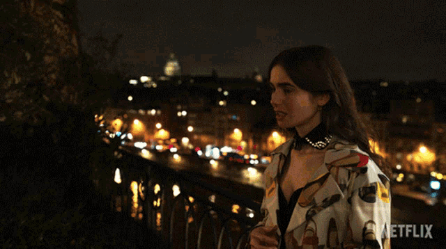 a woman stands on a balcony at night with a netflix logo in the corner