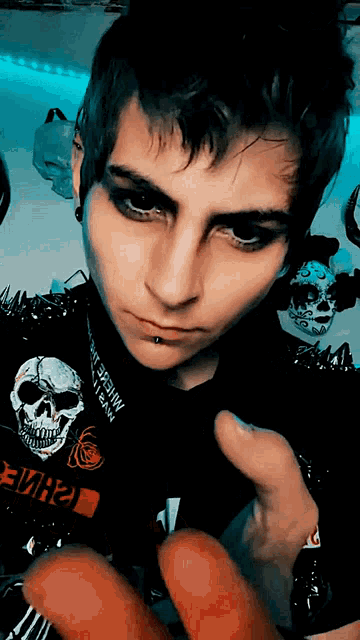 a person wearing a black shirt with a skull on it and a red sticker that says " e7h2 "