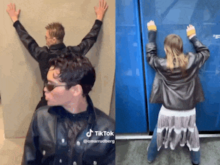 a man in a leather jacket is leaning against a wall and a woman in a leather jacket is dancing .