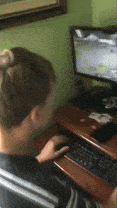 a man is playing a video game on his computer