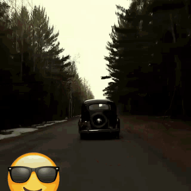 a car is driving down a road with sunglasses on