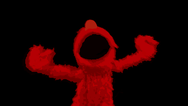 elmo from sesame street with his arms outstretched in the dark