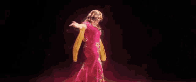 a woman is standing in the water with her arm outstretched