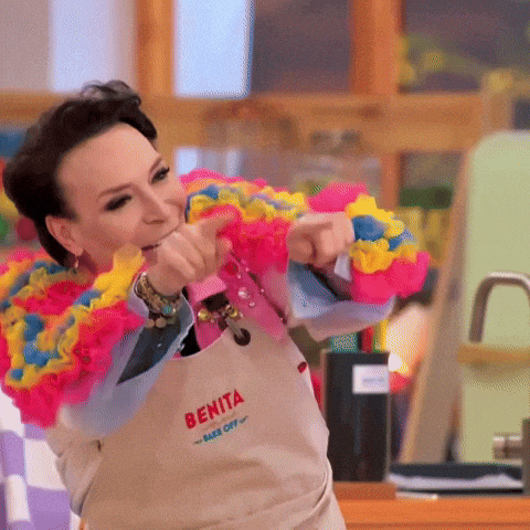 a woman wearing an apron that says benita is dancing