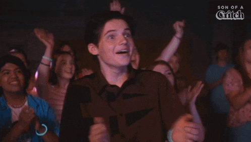a group of people applauding with the word whoo on the bottom right