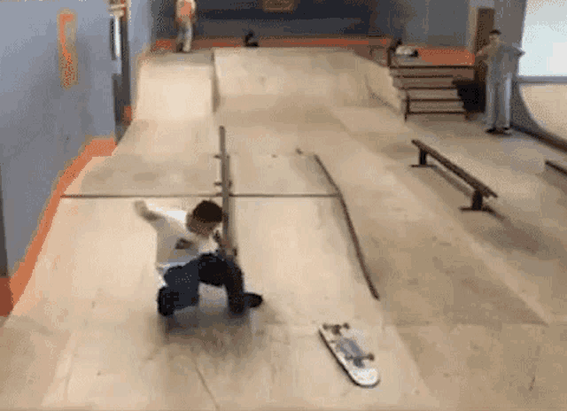 a young boy is riding a skateboard on a ramp at a skate park .