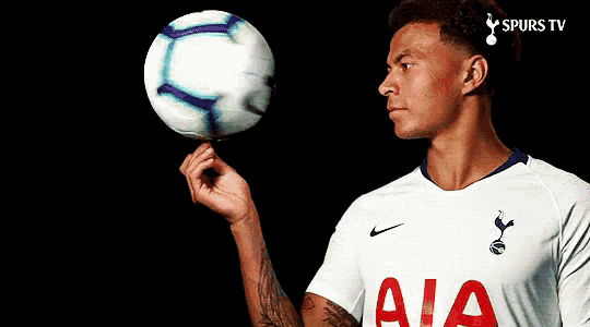 a man in an aia jersey holds a soccer ball