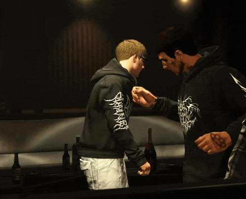 a man wearing a black hoodie with the word death on the sleeve
