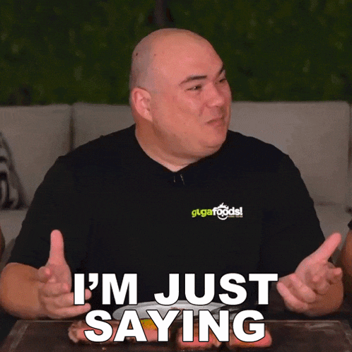a man in a black shirt that says i 'm just saying on it