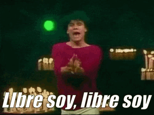 a man in a red shirt is standing in front of candles and says libre soy libre soy