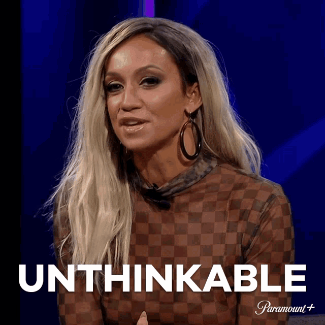 a woman is sitting in front of a sign that says unthinkable on it