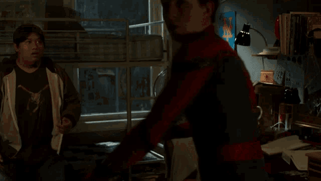 a man in a spiderman costume looks at the camera
