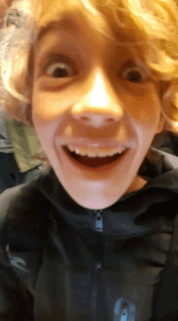 a close up of a person 's face with a surprised look on his face