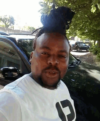 a man wearing a white shirt with a black letter c on it