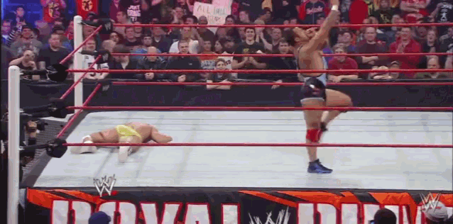 a wrestler in a ring with a sign that says royal rumble