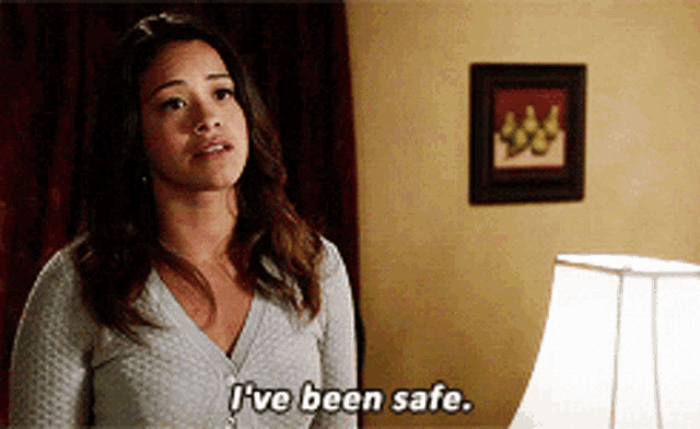 a woman says i 've been safe while standing next to a lamp