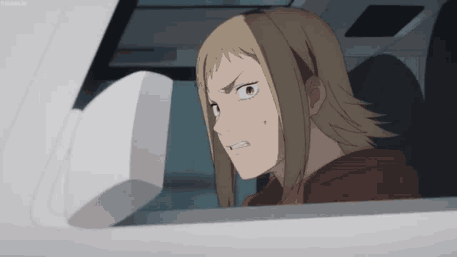 a woman in a red hoodie is sitting in a car