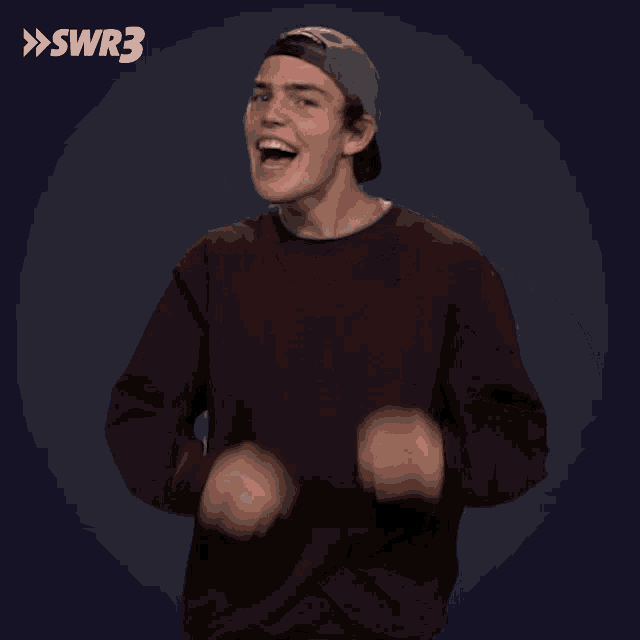 a man making a heart shape with his hands in front of swr3 logo