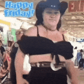 a woman wearing a cowboy hat and a bra is standing in a crowded room .