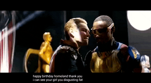 a man in a superhero costume is kissing another man .