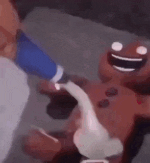 a close up of a person holding a cartoon character 's hand .