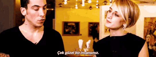 a man and a woman are standing next to each other and the woman is saying çok güzel bir insansiniz