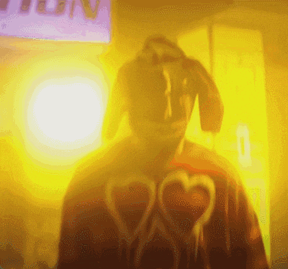 a blurry picture of a person wearing a red shirt with hearts on it