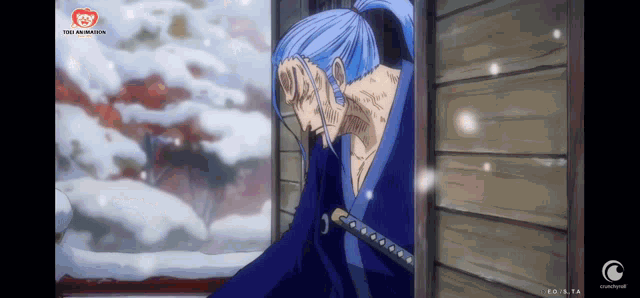 a man in a blue robe is holding a sword in his hand .