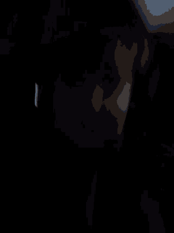 a blurry picture of a person in a dark room with a white light behind them
