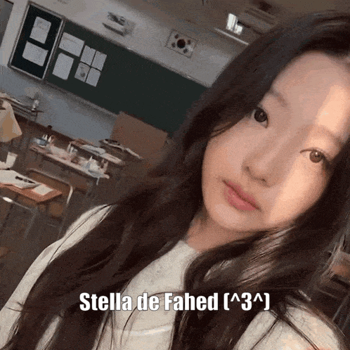 a girl taking a selfie in a classroom with the name stella de fahed on the bottom