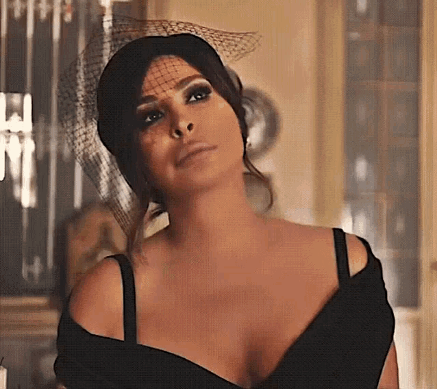 a woman wearing a veil and a black dress