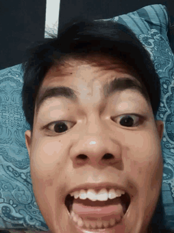 a close up of a person 's face with their mouth open