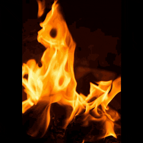 a man wearing sunglasses is surrounded by flames and smoke