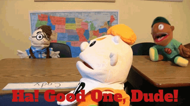 a puppet sitting at a desk with the words " hal good one dude " written on it