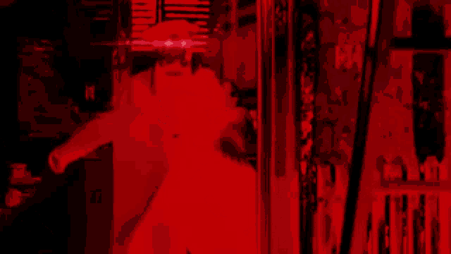 a red background with a person 's face in the middle