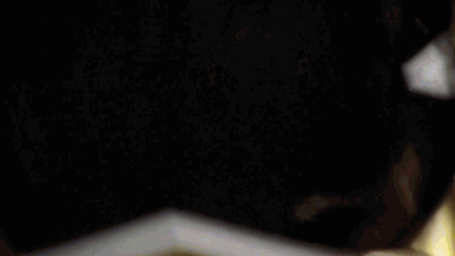 a close up of a candle being lit up in the dark